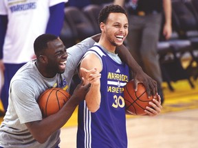 Golden State Warriors guard Stephen Curry (right) and Draymond Green joke around during practice yesterday in Oakland. (USA TODAY SPORTS)