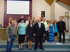 Several members of Lucknow Christian Reformed Church surrounded Rev Tim Leferink and his wife Karen to congratulate him on his ordination as Pastor of their congregation. Front from left: Eric VanHardeveld, Mandy VanHardeveld Karen Leferink, Pastor Tim Leferink.  Middle from left: Frances Saling holding Jayda Higgins, Bert Piel, Stuart Vandervaart, Jennie Bakker, Abigail Wellstead, Emmaly Brown, Bob Damsma. Back from left: Dave DeVries, Helen Vander Glas, Peter Brink, Al Spaling. May 30, 2015.