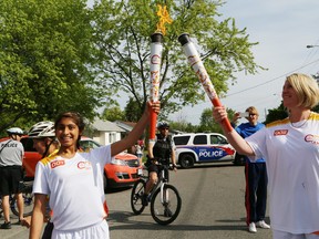 Torchbearers Maheen Awadia, a Grade 8 student at Churchill Public School, and Churchill vice-principal Kerri Monaghan participate in the Toronto 2015 Pan Am Games Torch Relay in Sudbury, Ont. on Wednesday June 3, 2015. Toronto is hosting the Pan Am Games from July 10 to 26 and the Parapan Am Games from August 7 to 15. John Lappa/Sudbury Star/Postmedia Network