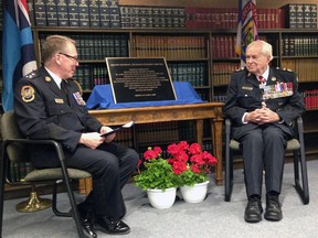 Ontario Police College Director Bruce Herridge, left, welcomes Maj.-Gen. Richard Rohmer, the new namesake of the school's library, at the formal announcement and plaque unveiling Wednesday morning. Rohmer completed his pilot training at the siite, a former air force base, more than 70 years ago.