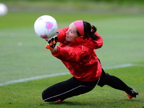 Canada's football player Erin McLeod dives during a training session at the London 2012 Olympic Games at the Grammer School Manchester, northern England August 5, 2012. (REUTERS/Nigel Roddis)