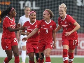 Sophie Schmidt #13 of Canada celebrates her goal with Josee Belanger #9 and Desiree Scott #11 and Ashley Lawrence #22 against England during their Women's International Friendly match on May 29, 2015 at Tim Hortons Field in Hamilton, Ontario, Canada.  (Tom Szczerbowski/Getty Images/AFP)