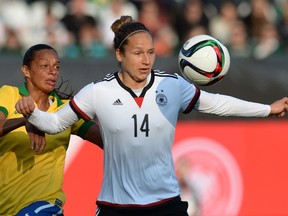 Germany's defender Babett Peter (R) and Brazil's midfielder Rosana vie for the ball during the friendly women football match between Germany and Brazil in the stadium in Fuerth, southern Germany, on April 8, 2015. (AFP PHOTO / CHRISTOF STACHE)