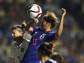 Japan's Yuika Sugasawa (C) fights for the ball against Italy's Claudia Squizzato (L) during their women's international friendly soccer match in Nagano, central Japan, May 28, 2015. (REUTERS/Toru Hanai)