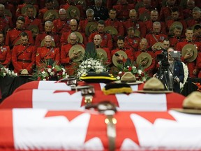 Royal Canadian Mounted Police officers attend the regimental funeral for three fellow officers who were killed last week in Moncton, New Brunswick, June 10, 2014. Justin Bourque, 24, was charged with murder in the slayings of the three Royal Canadian Mounted Police officers, Constables Fabrice Georges Gevaudan, 45; David Joseph Ross, 32, and Douglas James Larche, 40, during a shooting spree in the eastern Canadian city of Moncton. The shooting spree was one of the worst of its kind in Canada, where gun laws are stricter than in the United States and deadly attacks on police are rare.      REUTERS/Christinne Muschi