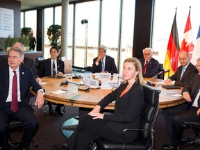 G7 foreign ministers pose as they sit at a table in the Hansemuseum on the second day of their meeting in the northern German city of Luebeck, April 15, 2015. Pictured are (L-R) British Foreign Secretary Philip Hammond, Canadian Foreign Minister Rob Nicholson, Japanese Foreign Minister Fumio Kishida, U.S. Secretary of State John Kerry, EU High Representative for Foreign Affairs and Security Policy Federica Mogherini, German Foreign Minister Frank-Walter Steinmeier, French Foreign Minister Laurent Fabius and Italian Foreign Minister Paolo Gentiloni.  REUTERS/Daniel Reinhardt
