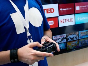 A Google employee uses a game controller to demonstrate the features of Android TV at the Google I/O developers conference in San Francisco June 25, 2014.  REUTERS FILE/Elijah Nouvelage