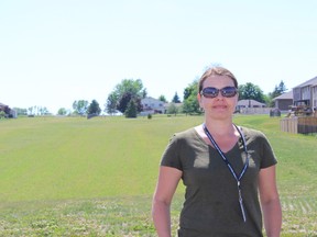 SAMANTHA REED/FOR THE INTELLIGENCER
Tanya Hill stands in front of a vacant lot on Essex Drive in the Cannifton Mills area. The city is working toward building a neighborhood playground on the lot. Hill says she would like to see more neighborhood parks built in the city.