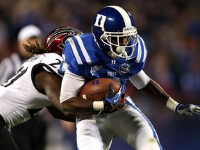 Camerron Cheatham of the Cincinnati Bearcats tries to stop Jamison Crowder of the Duke Blue Devils during their game at Bank of America Stadium on December 27, 2012. (Streeter Lecka/Getty Images/AFP)