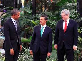 U.S. President Barack Obama (left), Mexico's President Enrique Pena Nieto (centre) and Canada's Prime Minister Stephen Harper talk before they pose for the official photo at the North American Leaders' Summit in Toluca, near Mexico City, Feb. 19, 2014. (HENRY ROMERO/Reuters)