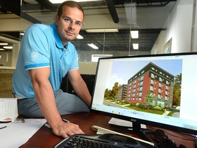 Mike Baldinelli shows a rendition of a proposed six-storey wood building in his office in Arva Thursday, above. Inset are other examples of wooden building designs by his London engineering firm, Strik Baldinelli Moniz. (MORRIS LAMONT, The London Free Press)