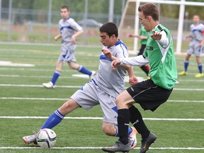 Nicholas Sivazlian of Sacre Coeur and Braden Guitard of L'Horizon fight for the ball at James Jerome Field  in Sudbury, Ont. on Thursday June 4, 2015.