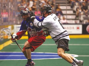 The Edmonton Rush’s John Lintz checks Toronto Rock forward Jeff Gilbert during Game 1 of the NLL final last week at the ACC. Game 2 in the best-of-three series is tonight in Edmonton. (JACK BOLAND/Toronto Sun)