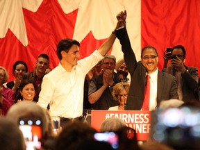 Amarjeet Sohi and Liberal Party leader Justin Trudeau raise each others' hands in front of a packed house at the Maharaja Hall in Edmonton on June 4, 2015 at his campaign launch. Sohi, a former city councillor, is running as a Liberal Party candidate for Mill Woods in the upcoming federal election.