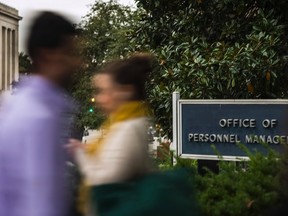 Workers arrive at the Office of Personnel Management (OPM) in Washington in this file photo taken Oct. 17, 2013. U.S. officials are investigating whether a massive cyber attack on the OPM originated in China, a source familiar with the matter said on Thursday. (REUTERS/James Lawler Duggan/Files)