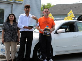 From left, City Taxi owners Madhee Meham and Suraj Kumar with taxi owner/operator George Corkey in Kingston, Ont. on Friday June 5, 2015. Corkey, with the help of Meham and Kumar, are raising money for Ride for Dad and prostate cancer research. Steph Crosier/Kingston Whig-Standard/Postmedia Network