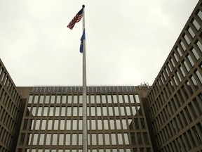 The U.S. national flag is pictured at the Office of Personnel Management building in Washington June 5, 2015. In the latest in a string of intrusions into U.S. agencies' high-tech systems, the Office of Personnel Management (OPM) suffered what appeared to be one of the largest breaches of information ever on government workers. The office handles employee records and security clearances  REUTERS/Gary Cameron