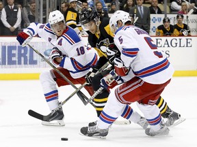 New York Rangers defencemen Marc Staal (18) and Dan Girardi (5) battle Pittsburgh Penguins centre Brandon Sutter (16) for the puck during NHL play at the CONSOL Energy Center. (Charles LeClaire/USA TODAY Sports)