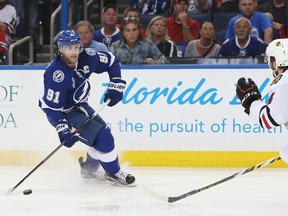 Lightning centre Steven Stamkos (left) skates with the puck against Blackhawks defenceman Niklas Hjalmarsson (right) during the second period in Game 1 of the 2015 Stanley Cup final in Tampa, Fla. (Kim Klement/USA TODAY Sports)