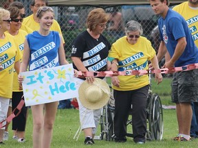 Cancer survivor Joyce Harrett rises from her wheelchair to walk the final survivors' lap stretch at the first SCITS Relay for Life fundraiser Friday. The student-organized event's target was $15,000 for the Canadian Cancer Society. (Tyler Kula, The Observer)