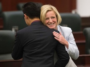 Edmonton-South West MLA Thomas Dang is congratulated by Premier Rachel Notley, as members of the NDP caucus are sworn-in at the Alberta Legislature, in Edmonton Alta. on Monday June 1, 2015. David Bloom/Edmonton Sun/Postmedia Network