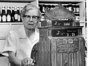 The late Edna Wilkey stands behind the hand-cranked cash register in a 1968 photograph accompanying a story about her grocery business at 537 Ontario St. (London Free Press files)