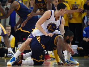 Cavaliers guard Kyrie Irving hits the floor after injuring his knee in overtime on Thursday night. (USA TODAY SPORTS)