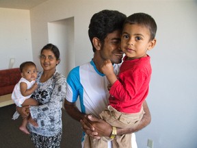 The Hashim family, left to right, Bibiroxana (8 months), Farzanah, Abdul and Zulfiqar (2) are happy to have emigrated to Canada in April. Abdul lived in refugee camps in Malaysia and Bangladesh since escaping his homeland of Myanmar 24 years ago. 
Derek Ruttan/The London Free Press/Postmedia Network