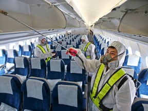 Employees from Korean Air disinfect the interior of its airplane in Incheon, South Korea, June 5, 2015. South Korean authorities squabbled on Friday over their handling of an outbreak of Middle East Respiratory Syndrome (MERS), as a fourth person died and five new cases were reported. REUTERS/Han Jong-chan/Yonhap