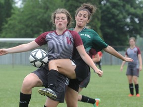 Wallaceburg Tartans' Kaitlyn Vancoillie, left, and St. Paul Wolverines' Emily Arruda compete for the ball in the second half of their pool finale Friday at the OFSAA 'AA' soccer championship at Kinsmen Park in Wallaceburg. The Tartans won 2-0 to finish in a second-place tie in their pool at 2-1-1, but they missed the playoffs. (MARK MALONE/The Daily News)