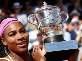 Serena Williams of the U.S. poses with the trophy during the ceremony after defeating Lucie Safarova of the Czech Republic during their women's singles final match to win the French Open tennis tournament at the Roland Garros stadium in Paris, June 6, 2015.  REUTERS/Jean-Paul Pelissier