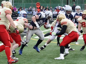 Sudbury Spartans running back Scott Smith tries to fight through a tackle during action against the Sarnia Imperials last Saturday. The Spartans head to Sault Ste. Marie to face the Steelers on Saturday evening. Ben Leeson/The Sudbury Star