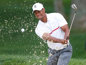Tiger Woods takes a shot from a bunker on the fourth hole during the third round of the Memorial Tournament Saturday at Muirfield Village Golf Club. (Brian Spurlock/USA TODAY Sports)