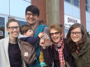 From left: Cait Barker, with her husband Matt Barker, son Jack, mother Gerry Toller-Lobe and sister Jessica Lobe, celebrate getting their folk fest tickets outside of Telus Field Saturday. KEVIN MAIMANN/EDMONTON SUN