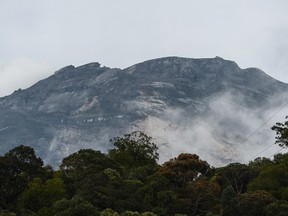 Malaysia's Mount Kinabalu is seen among mists from the Timpohon gate checkpoint a day after the earthquake in Kundasang, a town in the district of Ranau, June 6, 2015.  (MOHD RASFAN/AFP)