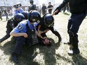 Interior Ministry members detain an anti-gay protester during the Equality March, organized by the LGBT community, in Kiev, Ukraine, June 6, 2015. (Reuters/Stringer)