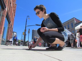 Paula McLean, a Sarnian studying art at university in Montreal, used a sidewalk as her canvass on Saturday June 6, 2015 in Sarnia, Ont. Christina Street was filled with spectators, and more than 200 art vendors, food vendors and demonstrating artists for the 13th annual Artwalk. The free event was also scheduled for Sunday, 11 a.m. to 5 p.m. Paul Morden/Sarnia Observer/Postmedia Network