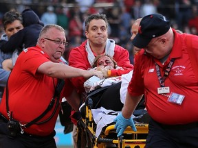 A fan is attended to by medical staff after she was hit by a broken bat during a game between the Boston Red Sox and Oakland Athletics at Fenway Park on June 5, 2015 in Boston. (Jim Rogash/Getty Images/AFP)