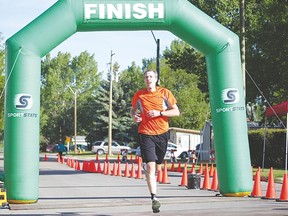 Shane Ellis was the first of hundreds of Tinman athletes to cross the finish line this morning just after 8:30 a.m. The event began at the pool at 7:30 a.m.