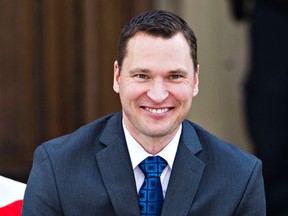 Minister of Municipal Affairs and Minister of Service Alberta Deron Bilous is sworn in during the swearing-in ceremony for the NDP government cabinet at the Alberta Legislature Building in Edmonton, Alta. on Sunday, May 24, 2015. Codie McLachlan/Edmonton Sun/Postmedia Network