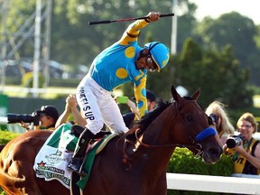 Victor Espinoza, celebrates atop American Pharoah, after winning the 147th running of the Belmont Stakes at Belmont Park on June 6, 2015 in Elmont, New York. With the wins American Pharoah becomes the first horse to win the Triple Crown in 37 years.  (Al Bello/Getty Images/AFP)