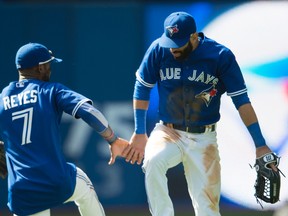 Jose Reyes (left) and Jose Bautista of the Blue Jays celebrate at the end of their team's 7-2 win over the Houston Astros on June 6, 2015, at Rogers Centre. Reyes and Bautista had four of Toronto's five stolen bases in the game. (NICK TURCHIARO/USA TODAY Sports)