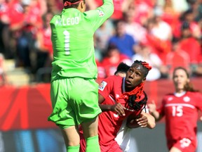 Erin McLeod grabs a high shot during Saturday's opening match against the Chinese. (Perry Mah, Edmonton Sun)