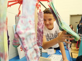 Kyle Brouillette, 13, of Carl A. Nesbitt Public School, showed off his business at the Rainbow District School Board Entrepreneur Fair at R. L. Beattie Public School in Sudbury, Ont. on Thursday June 4, 2015. About 65 Grade 7 and 8 students showcased their businesses at the event, which was hosted in partnership with the Learning Initiative and the Regional Business Centre. John Lappa/Sudbury Star/Postmedia Network