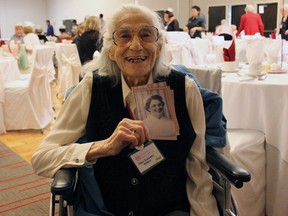 With a smile, Fran Morris, 97, relives the good times as a Kingston General Hospital nurse at the KGH Nurses' Alumnae reunion luncheon in Kingston, Ont. on Saturday June 6, 2015. Morris holds her graduation photo from 1940.  Steph Crosier/Kingston Whig-Standard/Postmedia Network