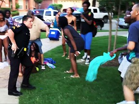 A police officer in McKinney, Texas, was suspended after he was caught on video wresting a girl to the ground and pulling his gun on teens. (YouTube)