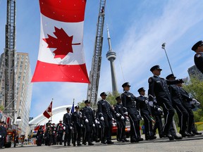 A Toronto Fire honour guard marches at a ceremony to mark those who have died in the line of duty or from work-related illnesses.
(MICHEAL PEAKE, Toronto Sun)
