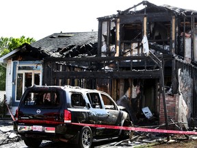 Extensive damage to a home and car at 15507 128 st in Edmonton, Alta., on Sunday June 7, 2015. The home was on fire last night, there is no word if there are any injuries.  Perry Mah/Edmonton Sun/Postmedia
