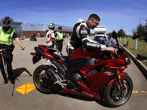 Police checks motorcycle for noise levels at the Nait Souch Campus in Edmonton, Alta., on Sunday June 7, 2015. The event today if for infromation only and no tickets were issueed. Perry Mah/Edmonton Sun/Postmedia