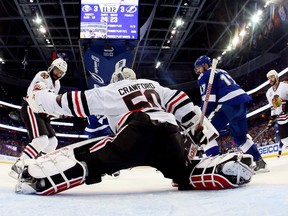 Corey Crawford #50 of the Chicago Blackhawks gives up a third period goal to Jason Garrison #5 of the Tampa Bay Lightning during Game Two of the 2015 NHL Stanley Cup Final at Amalie Arena on June 6, 2015 in Tampa, Florida. (Bruce Bennett/Getty Images/AFP)